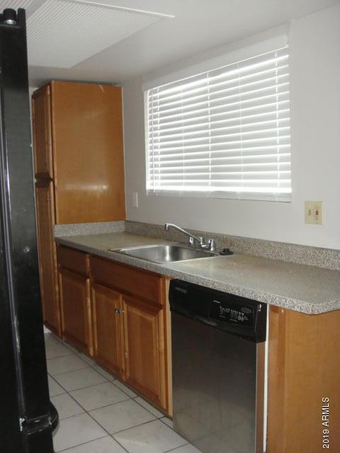 3315 West Loma Lane, Unit 4 Phoenix, AZ 85051 - Photo 13 of 13 a kitchen with granite countertop cabinets and window