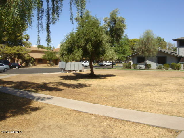 3315 West Loma Lane, Unit 4 Phoenix, AZ 85051 - Photo 2 of 13 a view of a swimming pool with an outdoor space and seating area