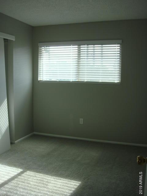 3315 West Loma Lane, Unit 4 Phoenix, AZ 85051 - Photo 9 of 13 a view of an empty room with a window