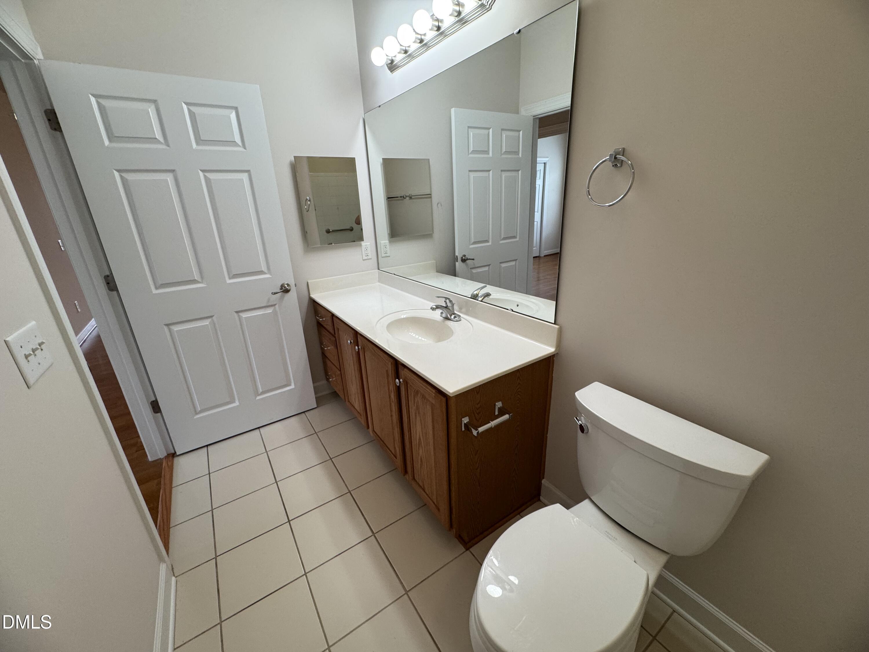 4622 Ivy Blossom Lane Raleigh, NC 27604 - Photo 14 of 15 a bathroom with a sink a toilet and mirror