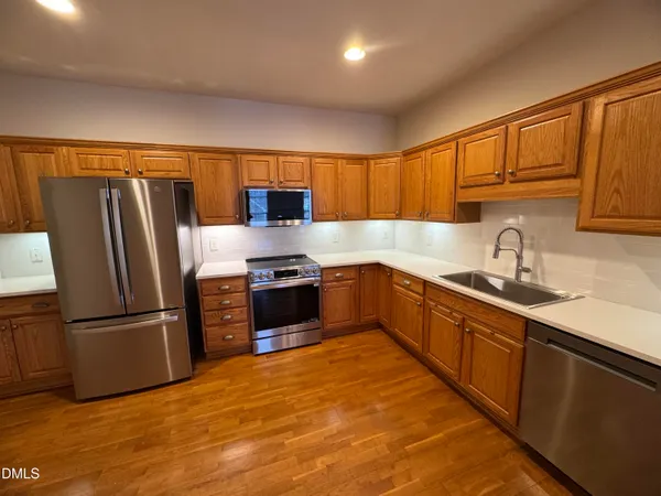 a kitchen with stainless steel appliances a refrigerator stove and sink