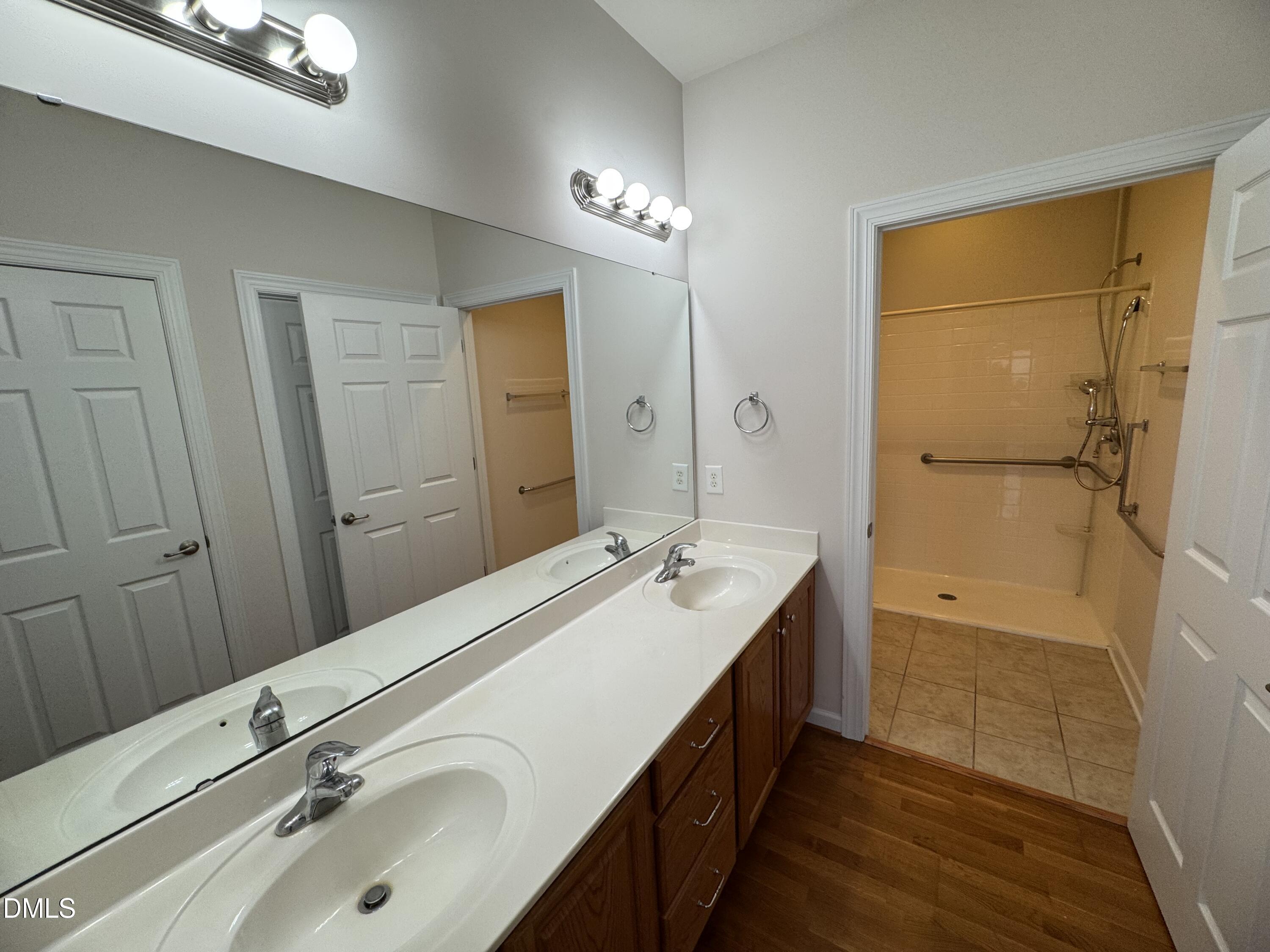 4622 Ivy Blossom Lane Raleigh, NC 27604 - Photo 9 of 15 a bathroom with a sink double vanity granite tub shower and a mirror