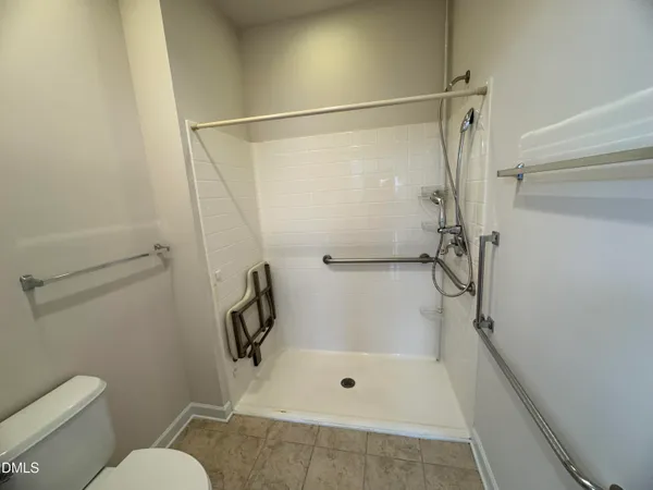 a bathroom with a shower and toilet