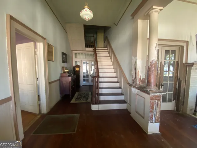 a view of entryway and hall with wooden floor