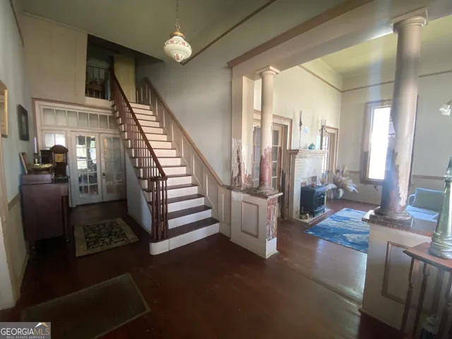 a view of an empty room and wooden floor