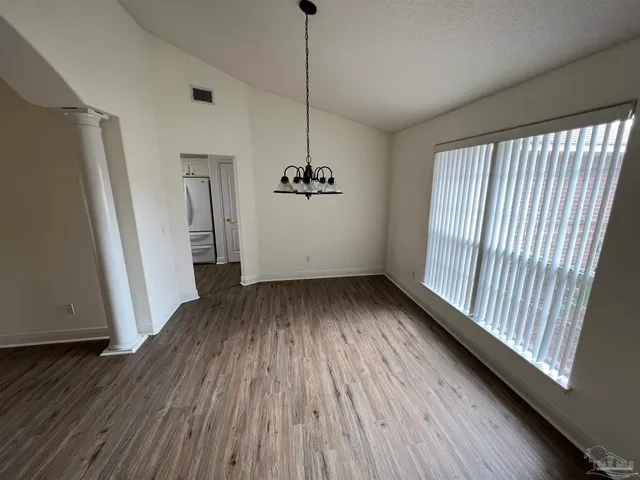 a view of a room with wooden floor and staircase