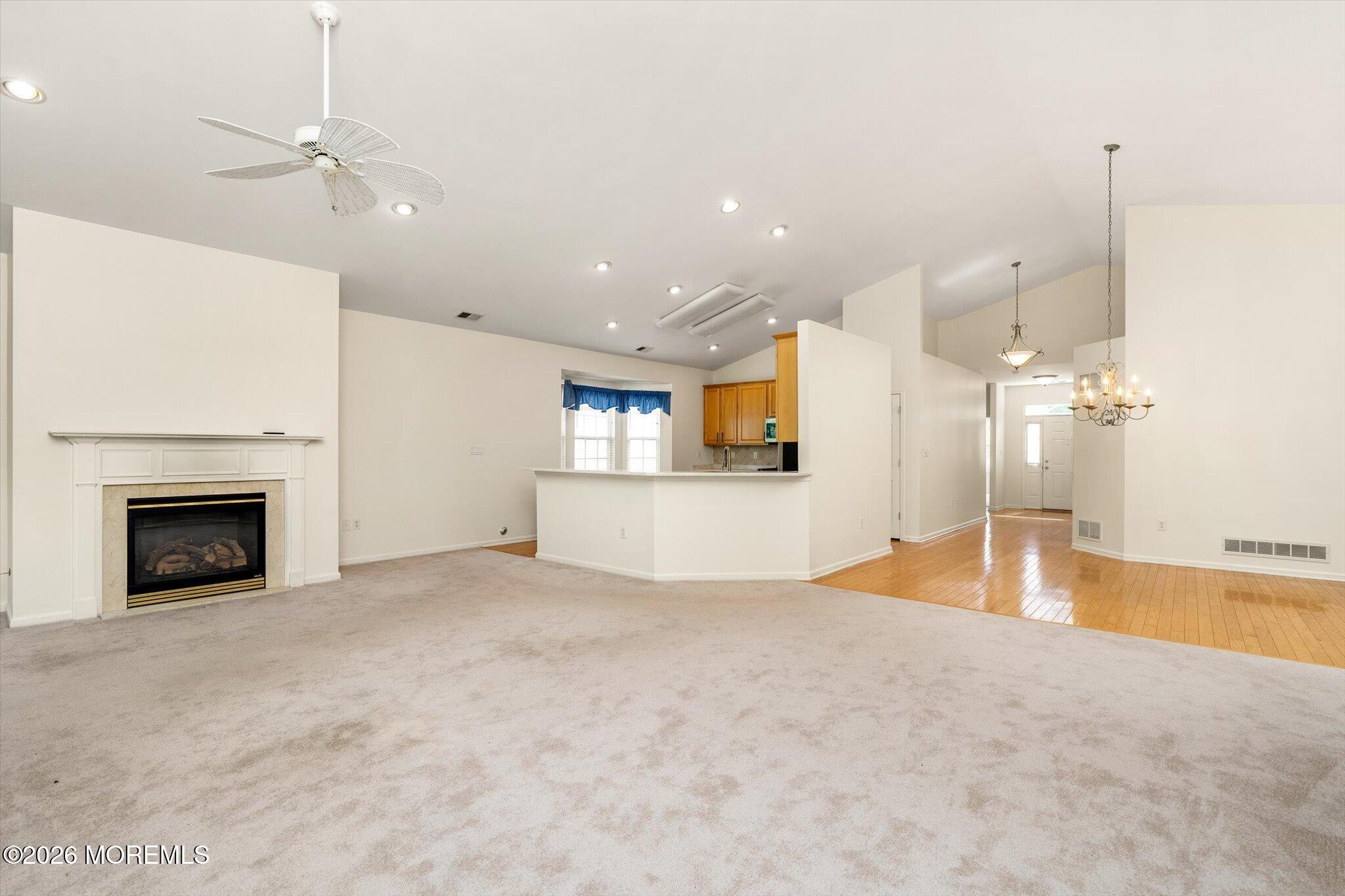 10 Powderhorn Way Allentown, NJ 08501 - Photo 8 of 27 a view of an empty room with a fireplace and a chandelier fan
