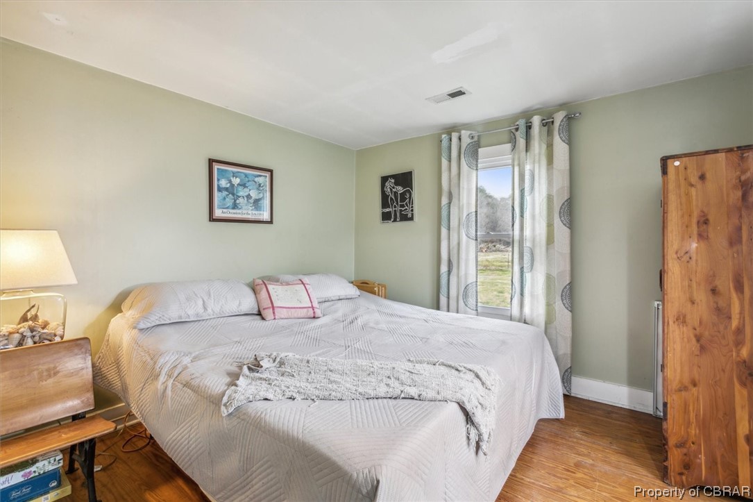 299 Greene Road Mathews, VA 23109 - Photo 23 of 40 a bedroom with a bed and a painting on the wall