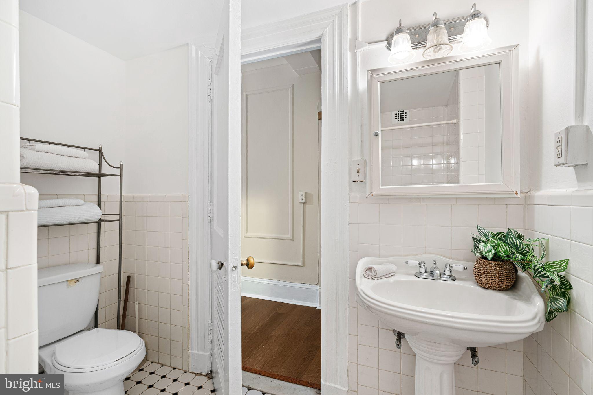 1324 Locust Street, Unit 717 Philadelphia, PA 19107 - Photo 6 of 12 a bathroom with a sink toilet and shower