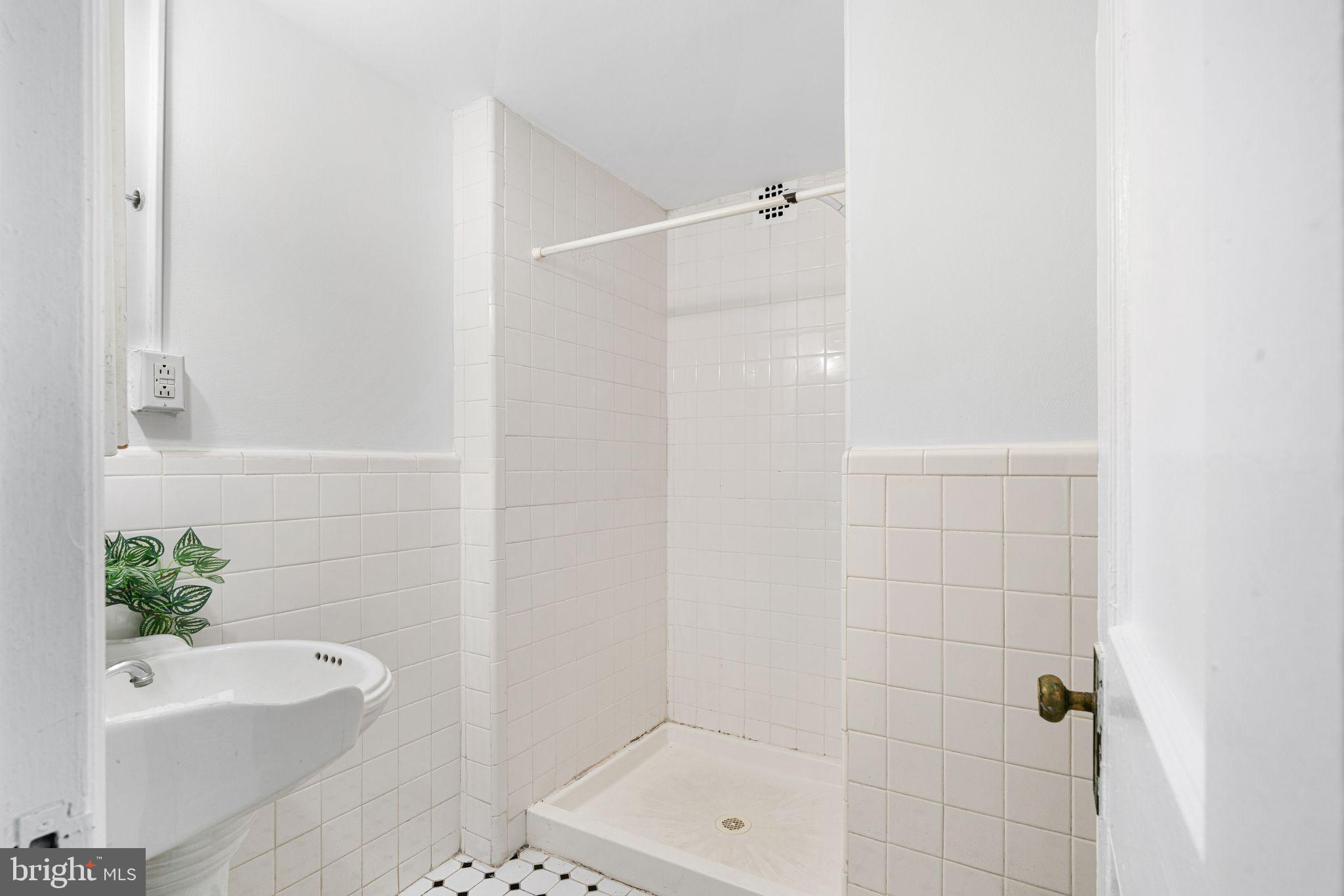 1324 Locust Street, Unit 717 Philadelphia, PA 19107 - Photo 7 of 12 a bathroom with a shower and a bathtub