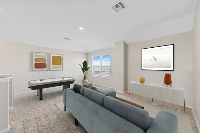 a living room with furniture and a potted plant