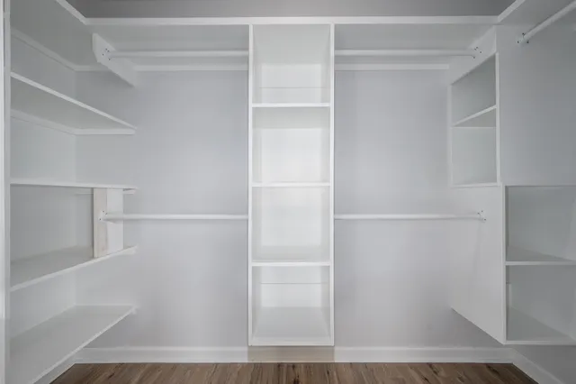a view of walk in closet with empty racks