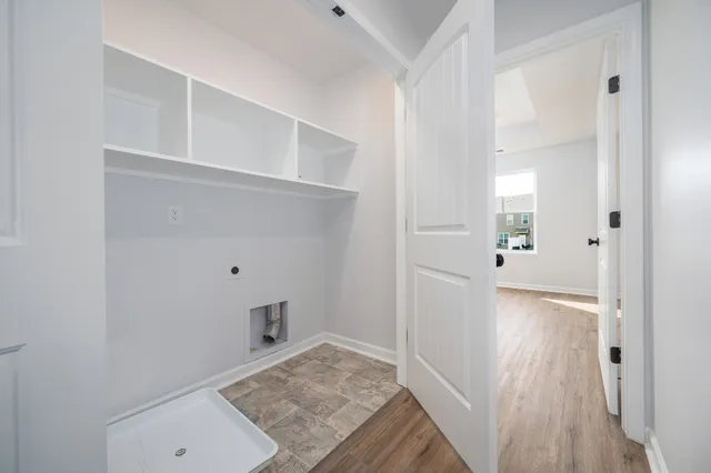 a view of hallway with wooden floor