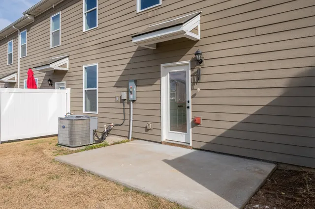 a view of brick house with potted plants