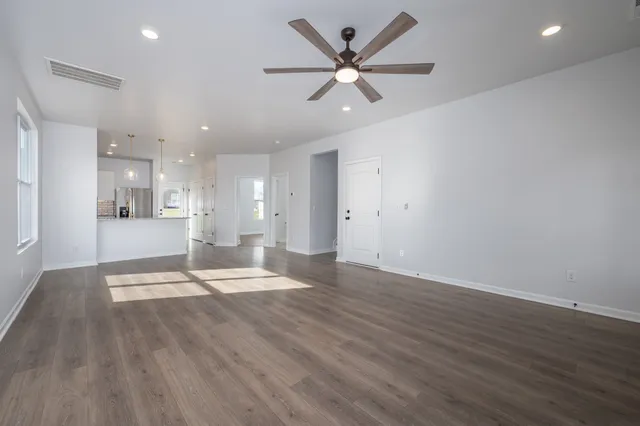 a view of a kitchen with a sink and refrigerator