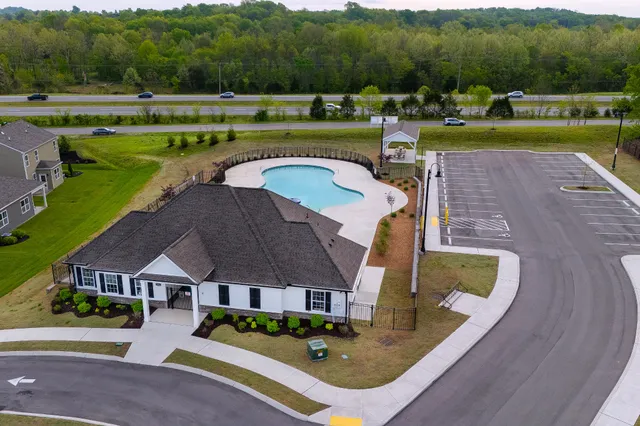 a view of a house with a swimming pool and outdoor space