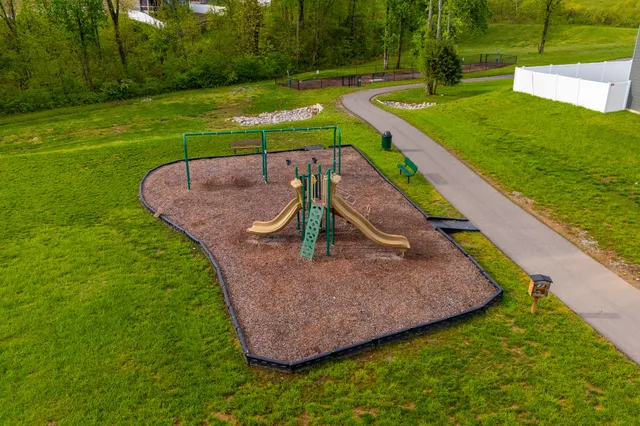 an aerial view of a house with a yard basket ball court and outdoor seating