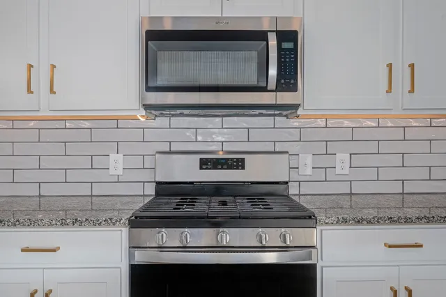 a stove top oven sitting inside of a kitchen