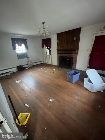 a view of empty room with furniture and fireplace