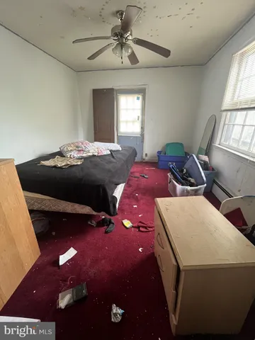 a bedroom with a bed and window