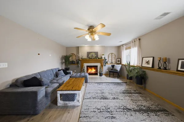 a living room with furniture and a fireplace
