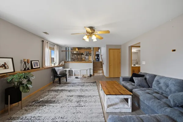 a living room with furniture a chandelier and a window