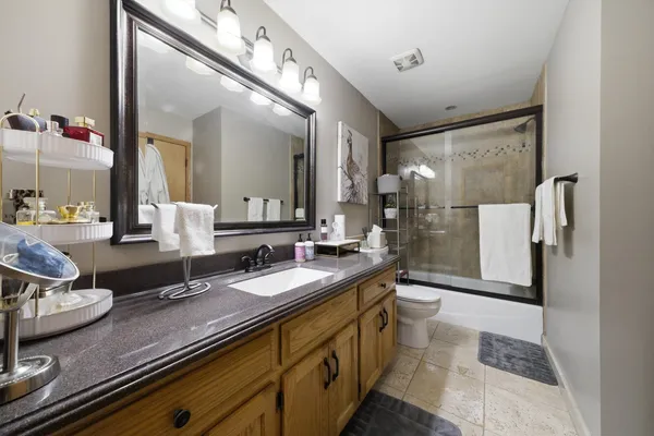 a bathroom with a double vanity sink mirror and shower