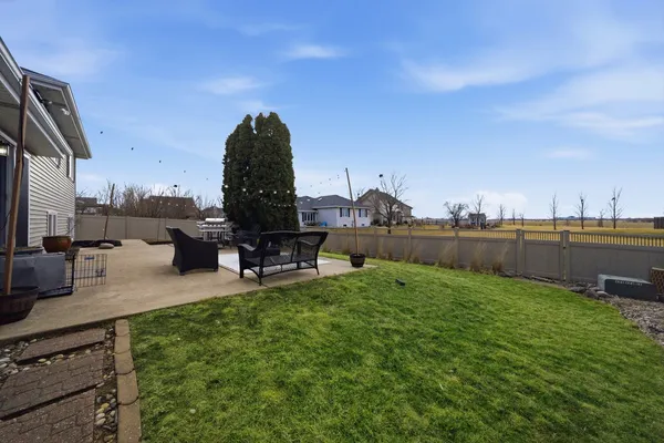 a view of a house with a yard and sitting area