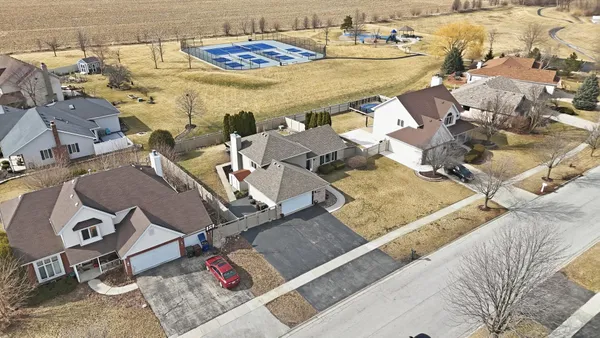 an aerial view of a backyard with swimming pool