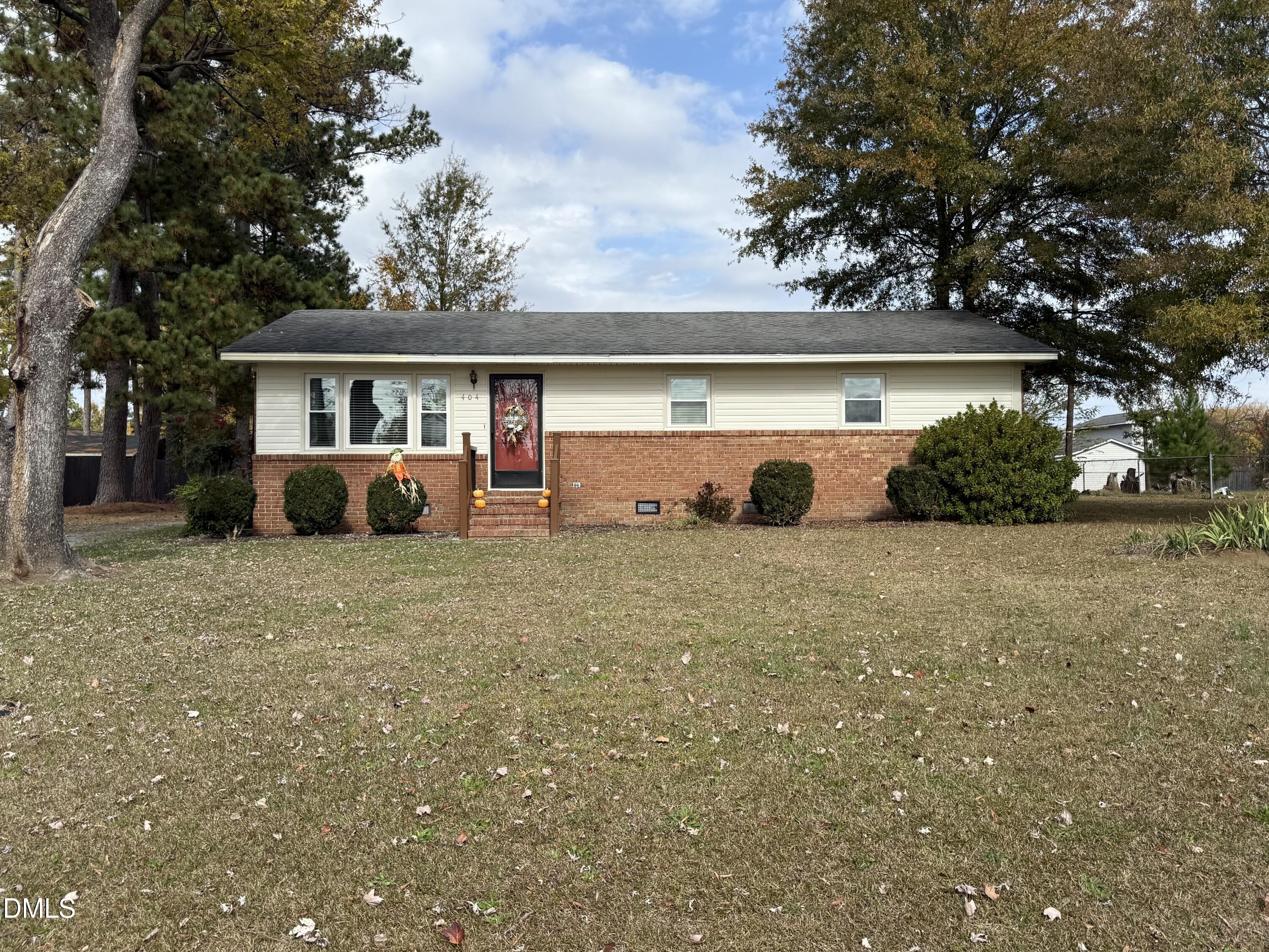 404 West A Street Erwin, NC 28339 - Photo 2 of 44 a view of a house with backyard and a tree