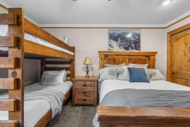 a bedroom with a bed and a painting on the wall