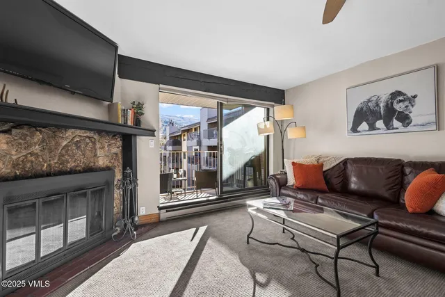 a living room with furniture a rug and a fireplace