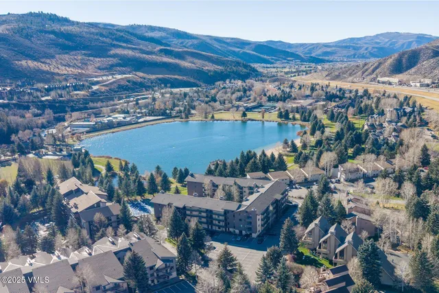 a view of a hallway with wooden floor and cabinet