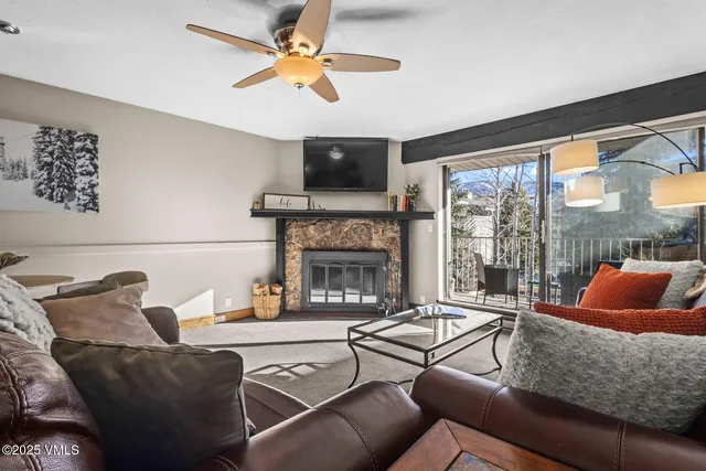a living room with furniture and a fireplace