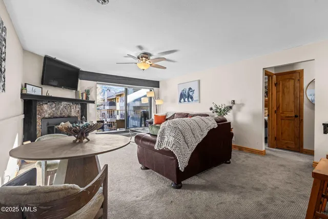 a living room with furniture a fireplace and a flat screen tv