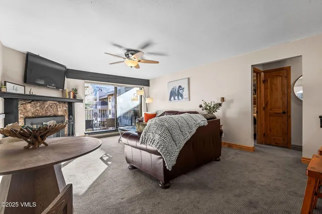 a spacious bedroom with a bed a couch and a chandelier