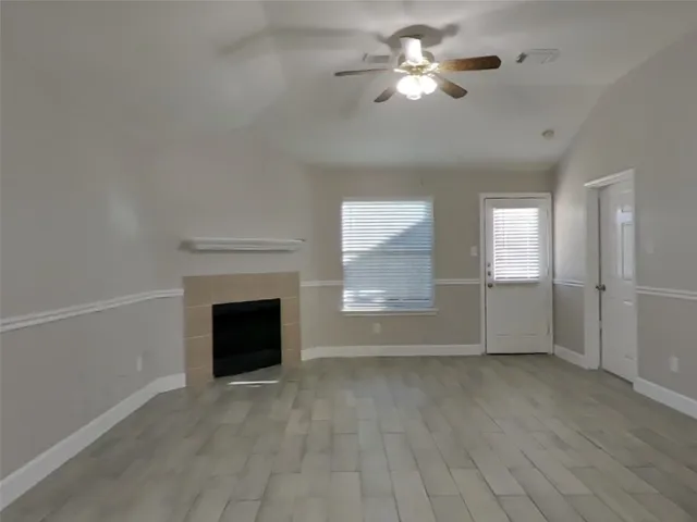 a view of empty room with fan and window