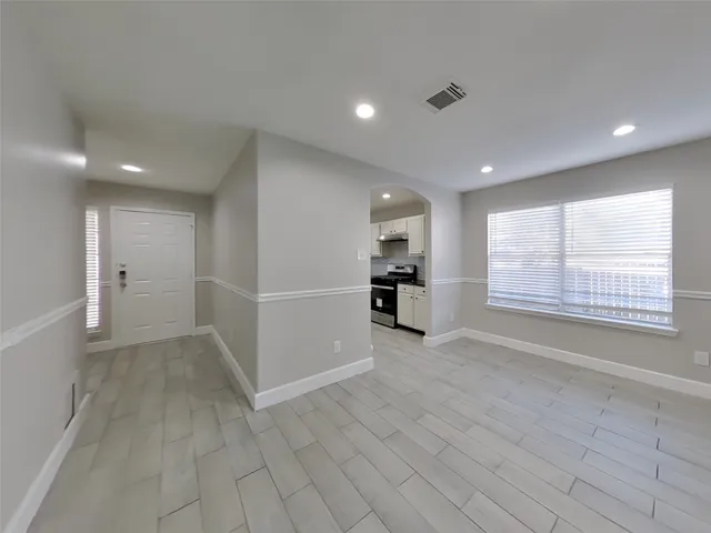 a view of an empty room with a window