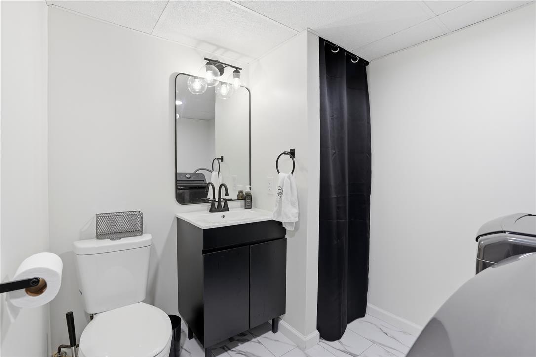 2918 Keystone Street Bethlehem, PA 18020 - Photo 28 of 54 A well-appointed lavatory with sleek, dark cabinetry and contemporary fixtures.