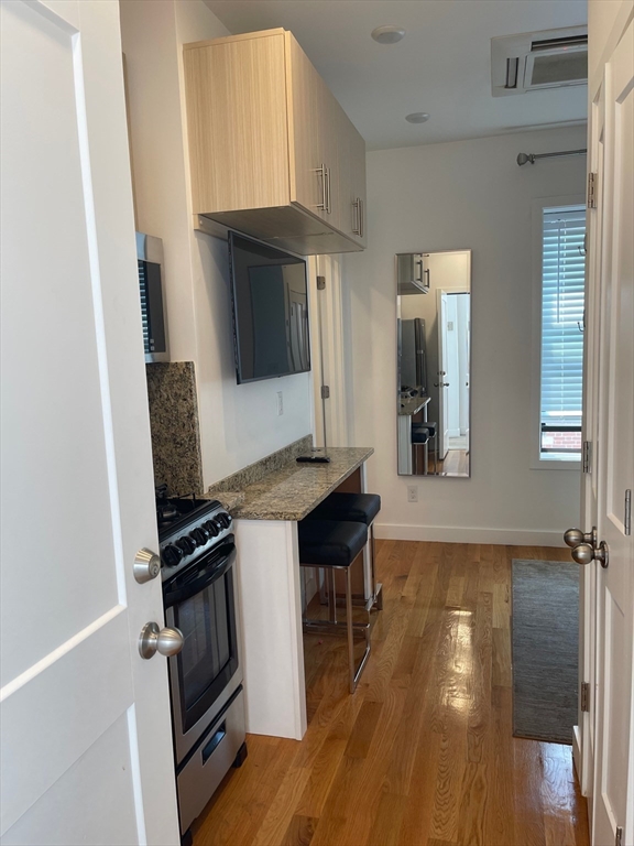 16 5th Street, Unit 31 Chelsea, MA 02150 - Photo 23 of 25 a kitchen with a sink appliances and cabinets