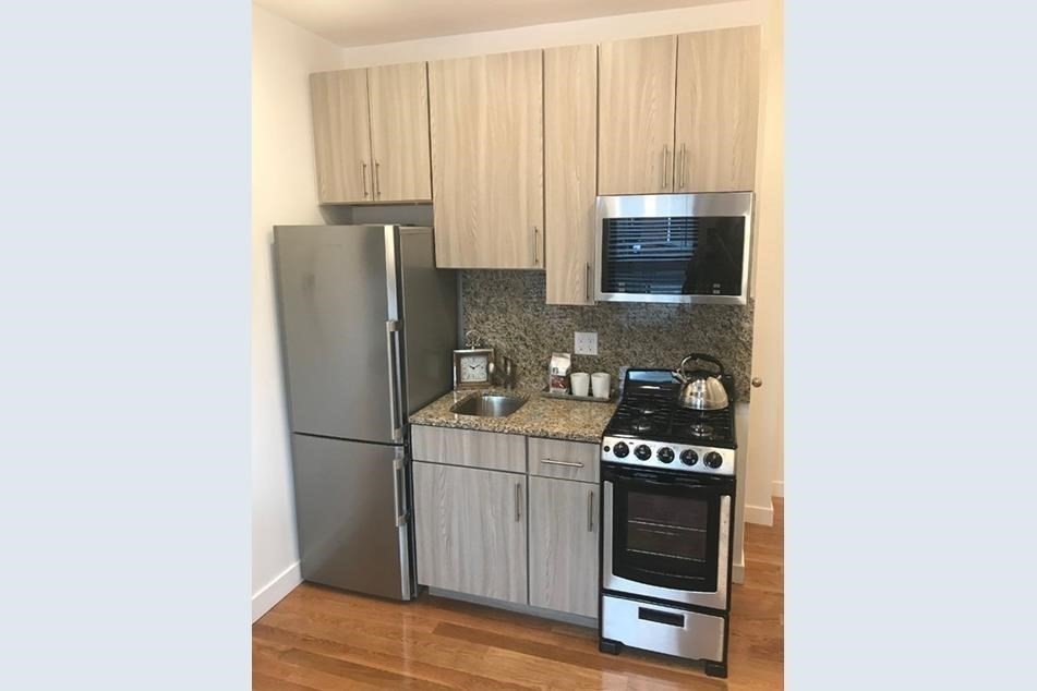 16 5th Street, Unit 31 Chelsea, MA 02150 - Photo 3 of 25 a kitchen with a refrigerator and a stove top oven