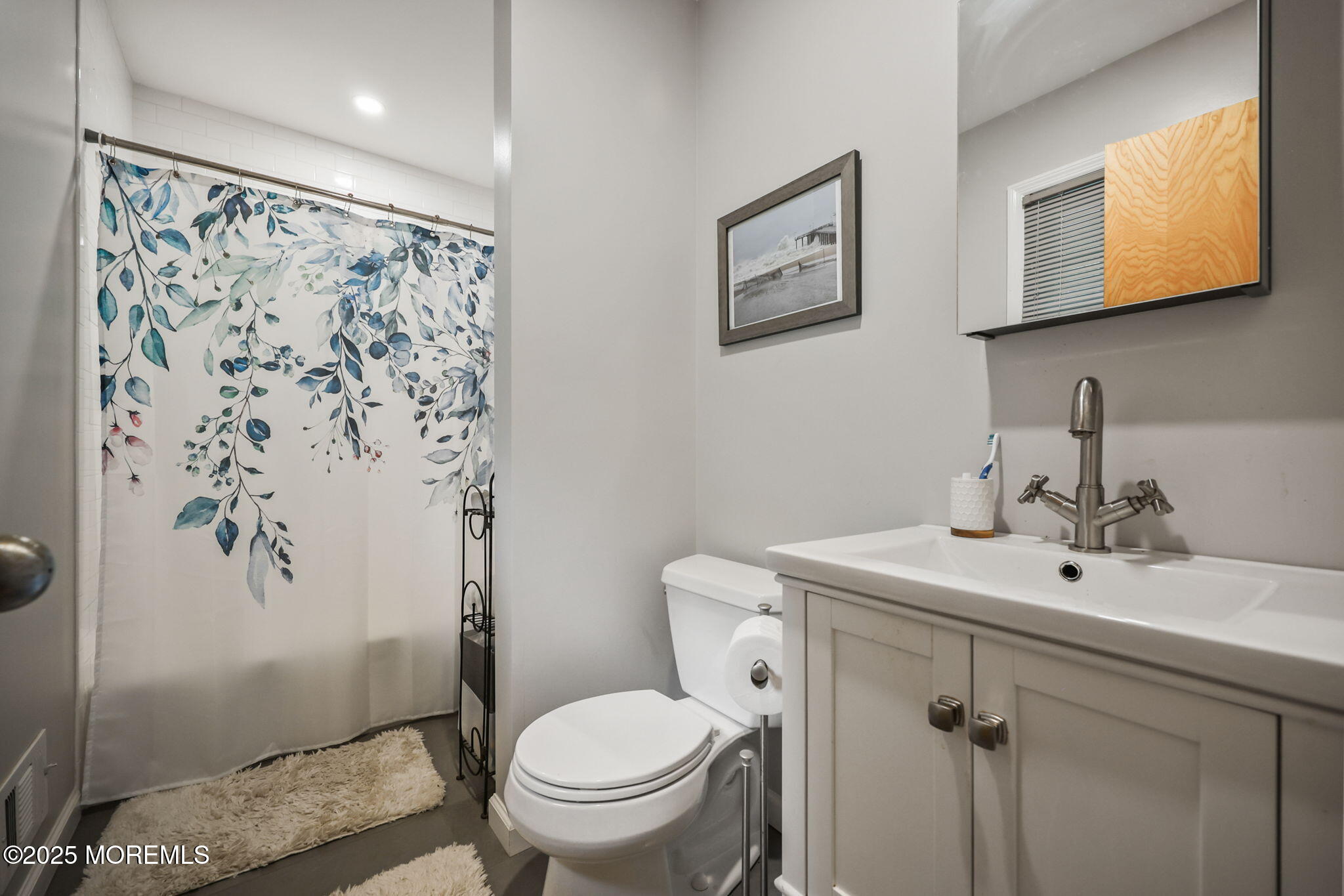 724 South Riverside Drive Neptune Township, NJ 07753 - Photo 18 of 39 a bathroom with a sink toilet and mirror