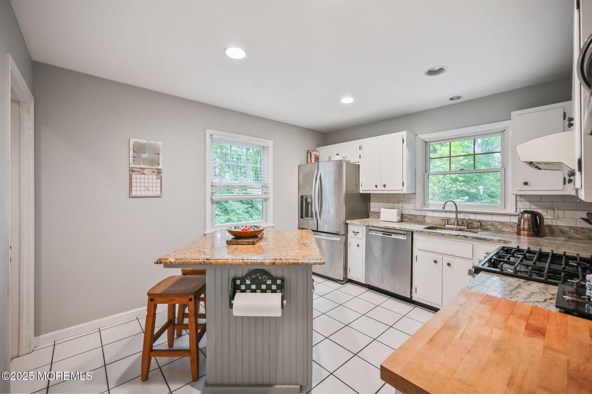 724 South Riverside Drive Neptune Township, NJ 07753 - Photo 7 of 39 a kitchen with a refrigerator and a stove top oven