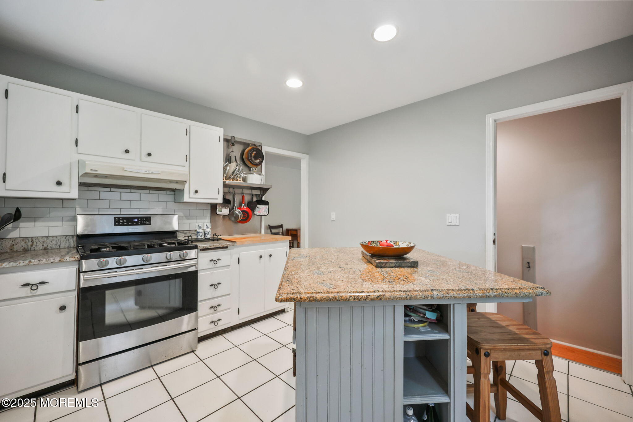 724 South Riverside Drive Neptune Township, NJ 07753 - Photo 9 of 39 a kitchen with granite countertop cabinets and white appliances