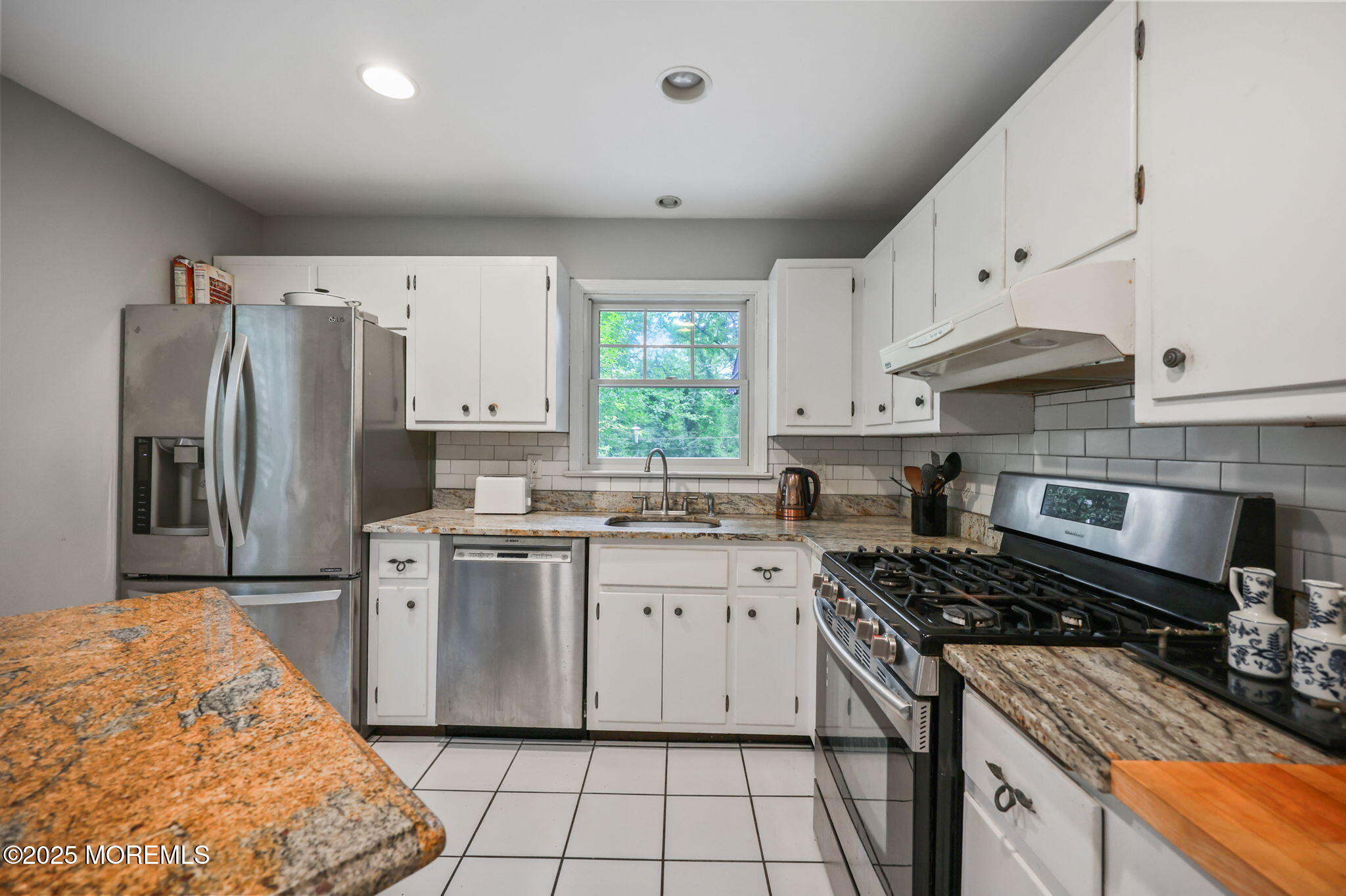 724 South Riverside Drive Neptune Township, NJ 07753 - Photo 10 of 39 a kitchen with a stove a sink and a refrigerator