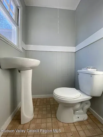 a white toilet sitting next to a white sink