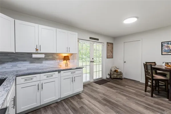 a kitchen with sink cabinets and wooden floor
