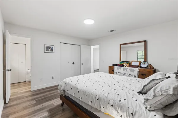 a bedroom with double bed and a closet