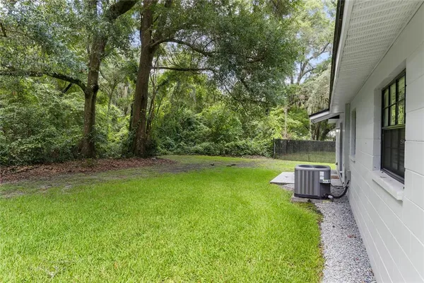 a view of a backyard with trampoline