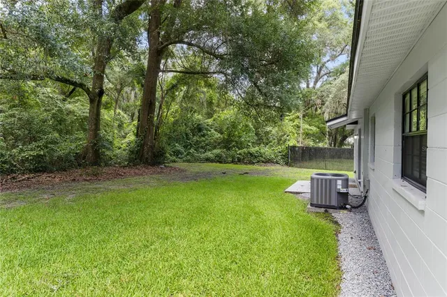 a view of a backyard with trampoline